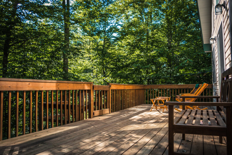 Sunny outdoor wooden deck surrounded by trees