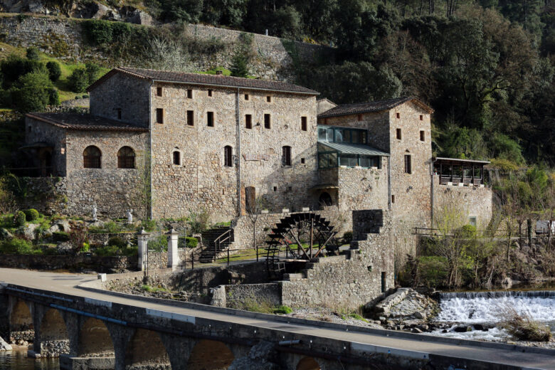 Historic stone building and water wheel in Languedoc