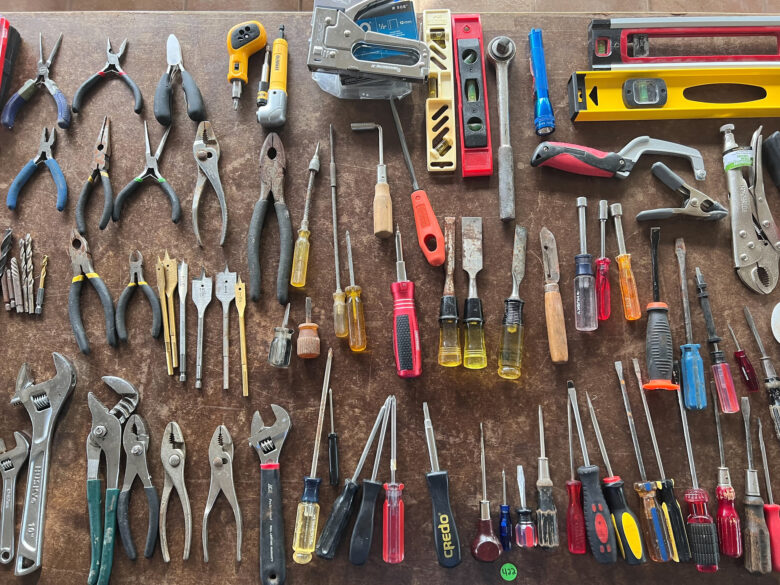 Selection of hand tools laid out on a table