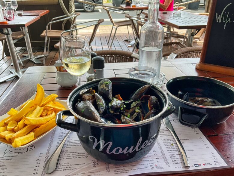 A pot of moules and a plate of frites at a French restaurant