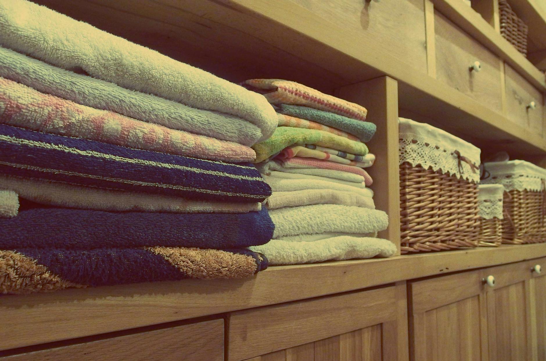 stack of towels on shelf in a wardrobe