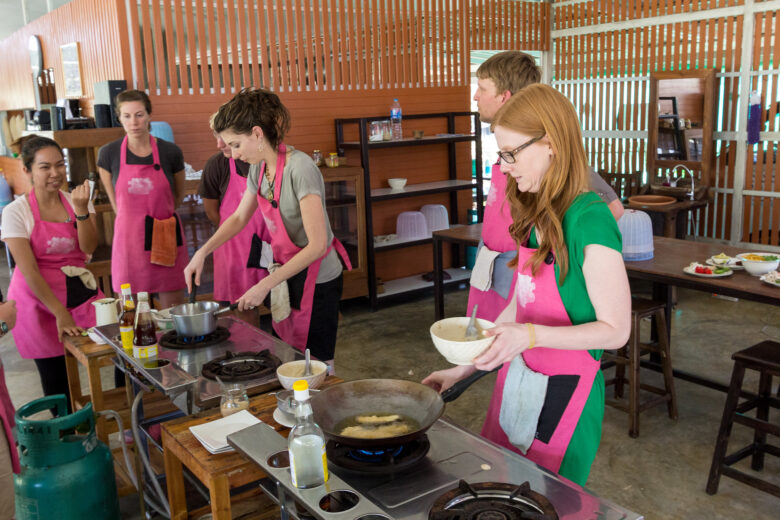 A group of people taking a cooking class