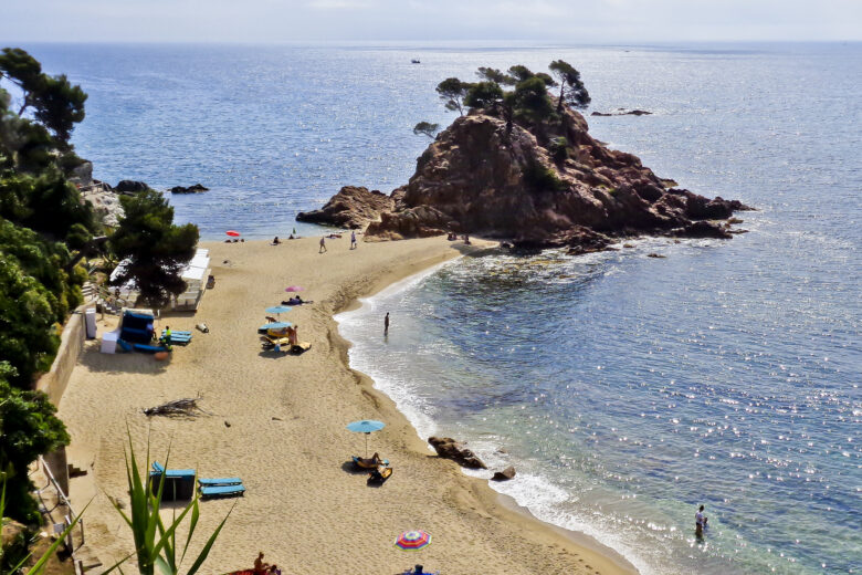 A sweep of sand and sunbathers in the Costa Brava