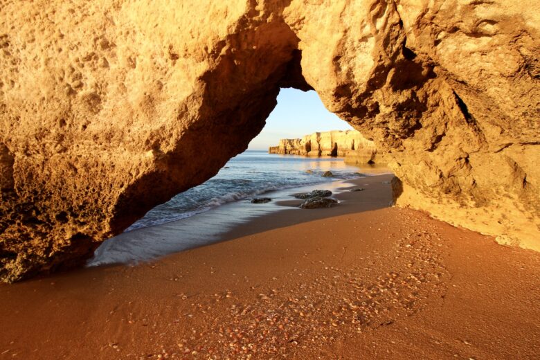 Path through the rocky cliffs on the beach in Coeval, Algarve