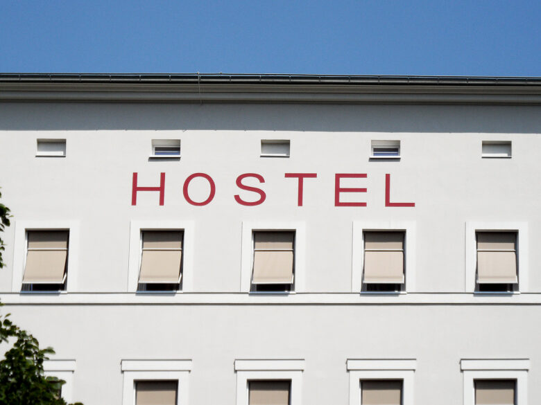 Exterior of a hostel building with the sign 'hostel' displayed