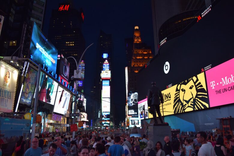 A bustling Times Square in New York at night