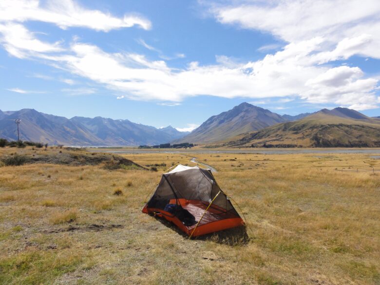 A tent set up in the middle of a field