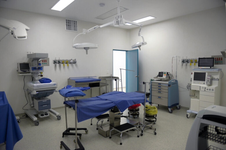 A hospital room with a bed and machines