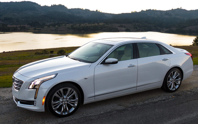 Silver car parked in the middle of a desert area of Arizona