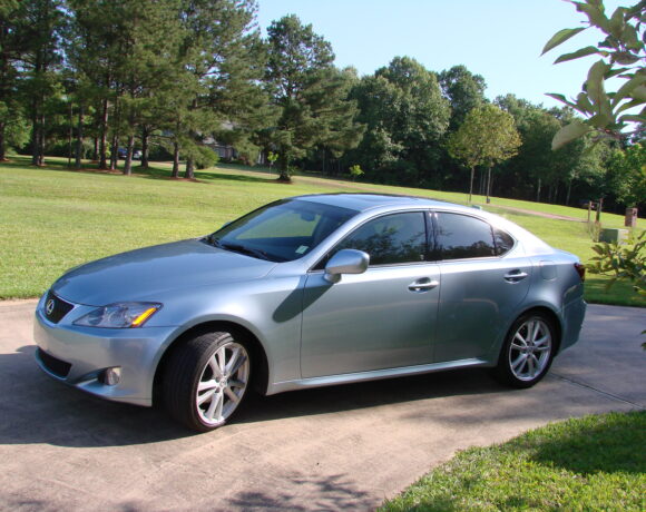 New silver car parked up in a driveway