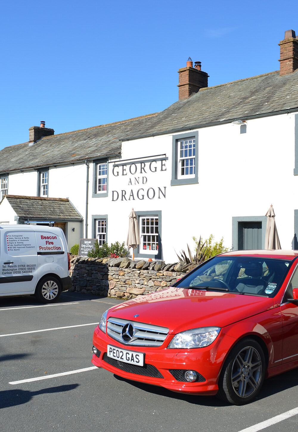 Cars parked outside of a country pub in England