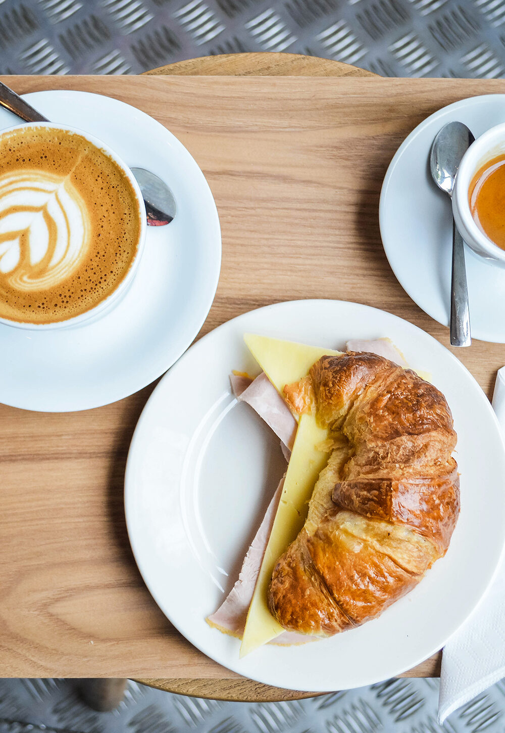 Tray with coffee, a filled croissant and an espresso