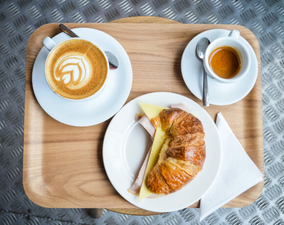 Tray with coffee, a filled croissant and an espresso