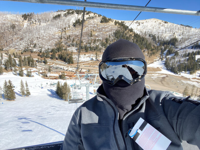 Person on a ski slope wearing full ski suit and goggles