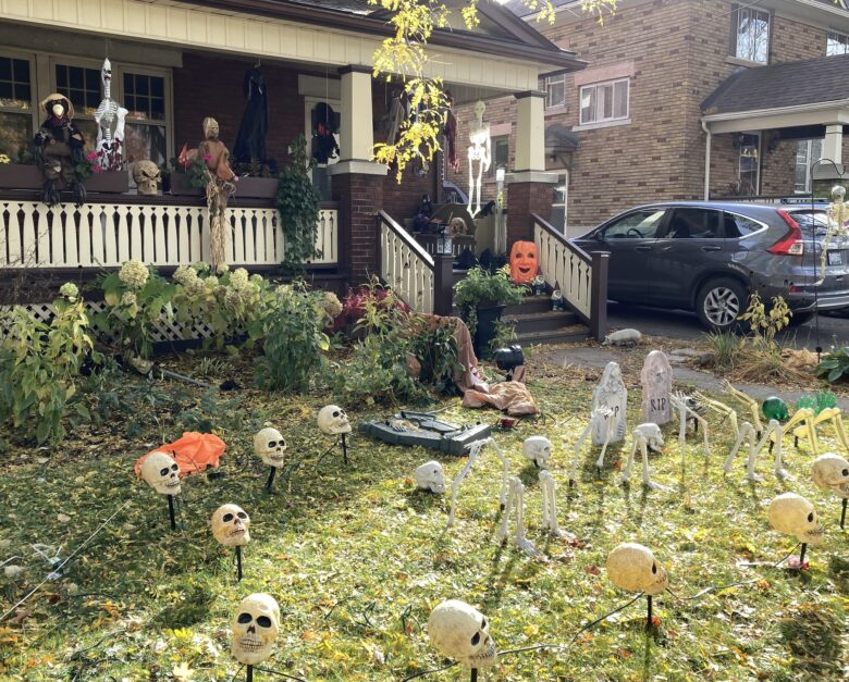 Skulls and skeletons dotted across a front garden