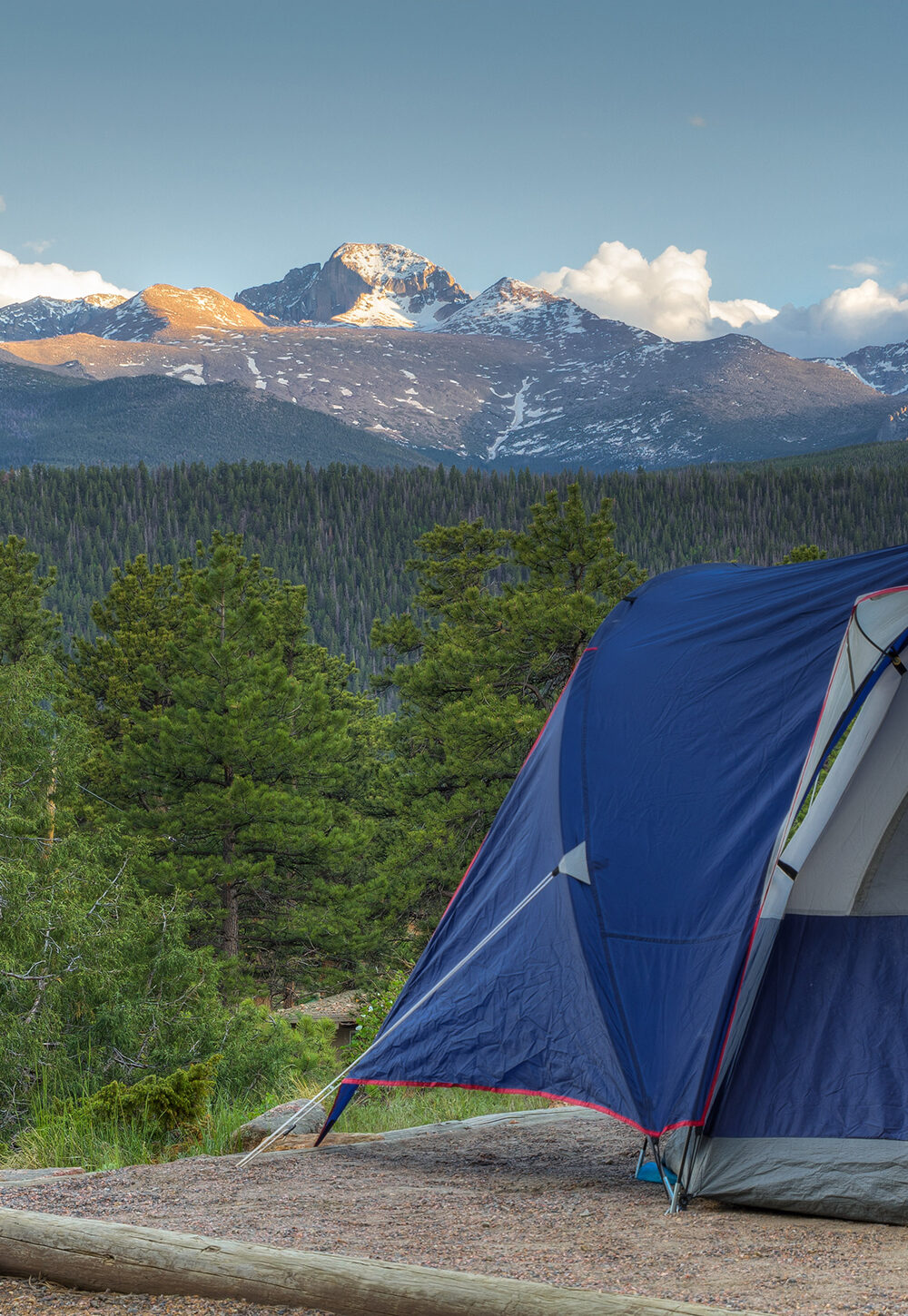 Tent pitched overlooking mountains and woods