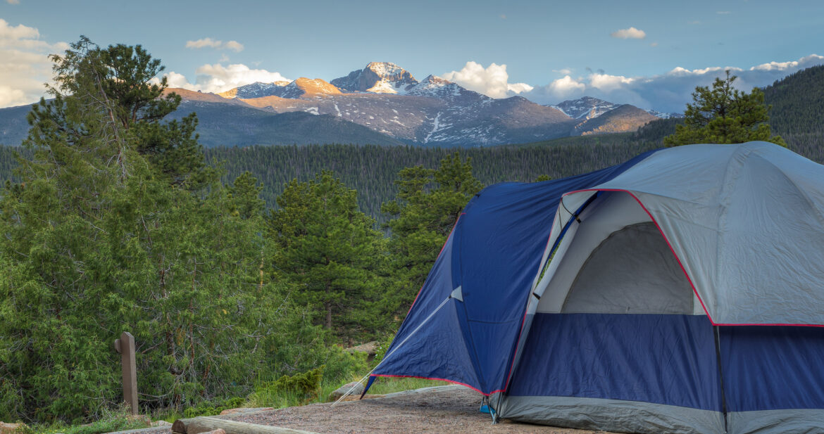 Tent pitched overlooking mountains and woods