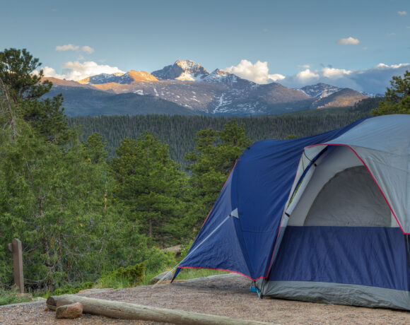 Tent pitched overlooking mountains and woods