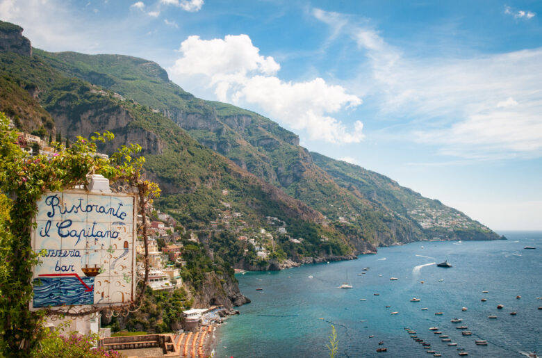 Hand-painted sign advertising a pizzeria on a hill in the Amalfi Coast