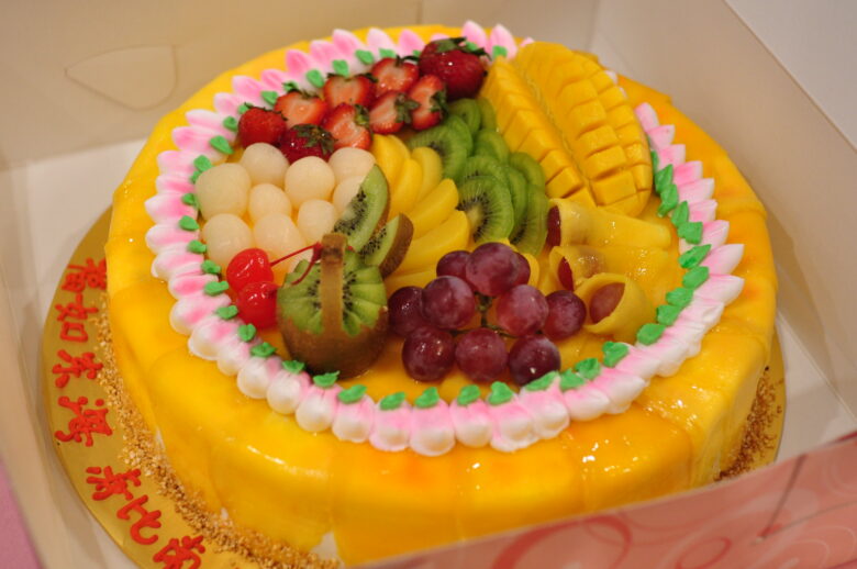 Asian birthday cake topped with fresh fruit