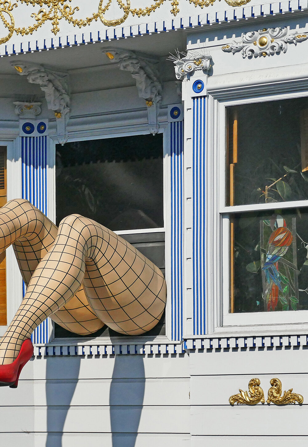 Pair of model legs sticking out of a window in San Franscisco