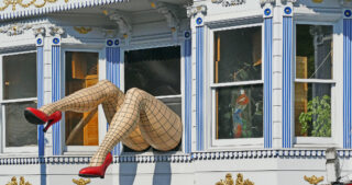 Pair of model legs sticking out of a window in San Franscisco