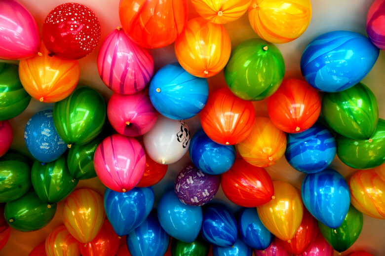 Lots of colourful balloons covering the ceiling